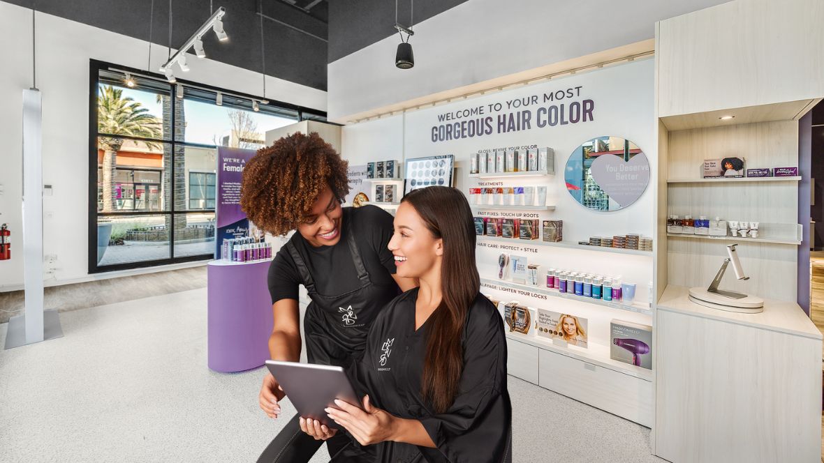 1180x664 Two women at Madison Reed, discussing hair color and style.
